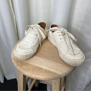 Both white leather sneakers